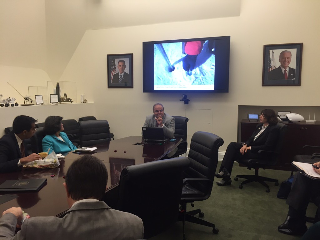 Cortada delivers talk to members of the president's administration in the OSTP Conference Room. Sitting near him on a shelf is a piece of the Allende Meteorite, the oldest known natural object.